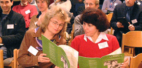 Conference participants looking at the PAN UK Annual Review